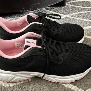 Woman’s size 9 Reebok’s.  Black and pink.  Steel toe.  Never worn.  Brand new.